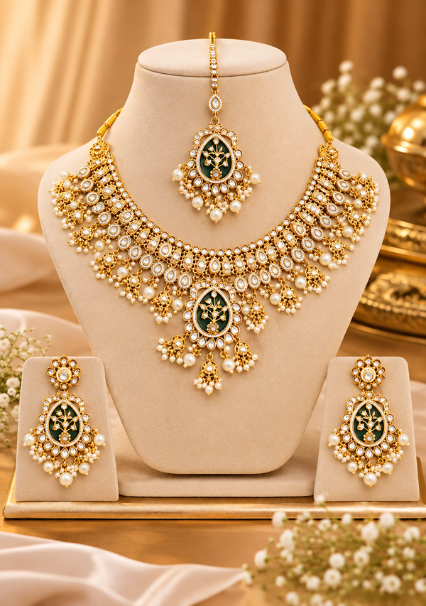 Bridal necklace, drop earrings and maang tikka with dark floral enamel motifs and pearl-style fringes on cream stands.